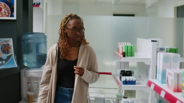 African American Client Analyzing Pharmaceutical Products Drugstore Shelves Buy Medicine — Stock Video