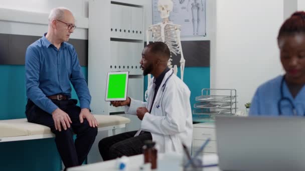 African American Medic Pointing Tablet Greenscreen Display Looking Chromakey Template — Vídeos de Stock
