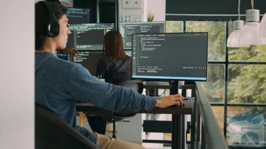 Bilgisayar ekranında Html betiği ile çalışan Asyalı sistem mühendisi, terminal penceresini kullanıyor. Yazılım geliştirici kodlama sistemi arayüzü, ofis alanına ai algoritması yazma.