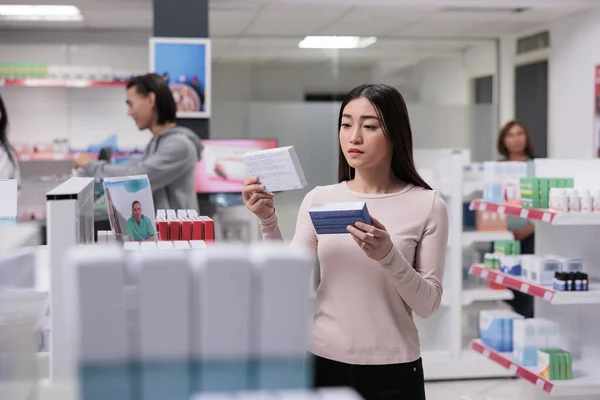 Woman Client Examining Boxes Vitamins Dispersed Shelves Pharmacy Looking Prescription — Stock Photo, Image