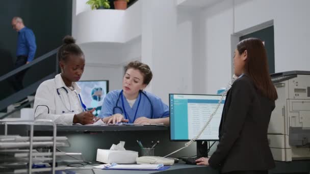 Diverse Specialists Working Checkup Appointment Forms Hospital Reception Counter Using — Stock video