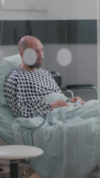 Vertical Video Stressed Sick Man Sitting Bed Waiting Respiratory Treatment — Stock Video