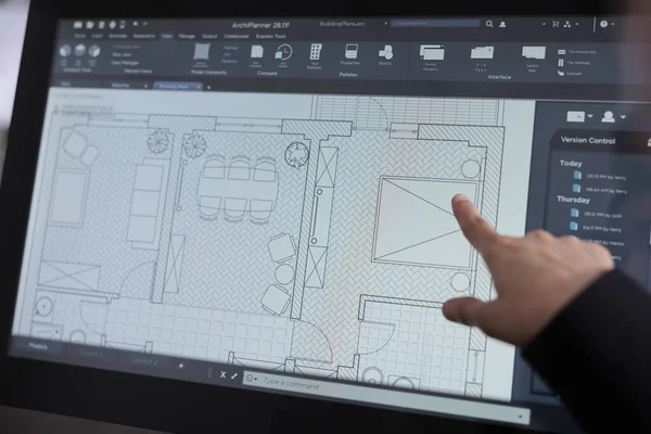 Room floor planner software close up, real estate studio project, interior design 2d creator app on computer screen. Apartment wireframes, woman pointing with finger on draft on monitor