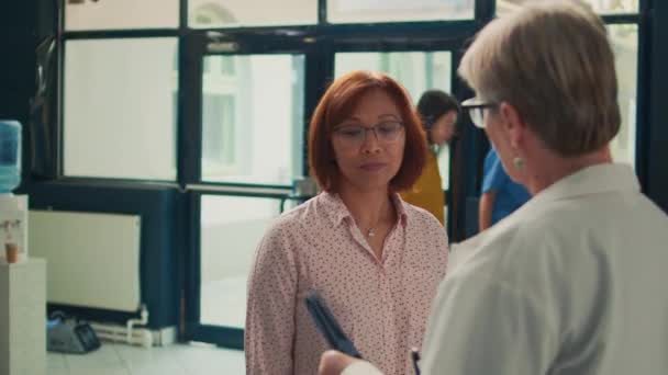 Asian Patient Analyzing Radiography Scan Specialist Medical Clinic Lobby Looking — Stock Video