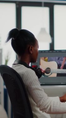 Afrikalı video editörü, yaratıcı stüdyo ofisinde çalışan post prodüksiyon yazılımında kamera gülümseyen kurgu video projesine bakıyor. Profesyonel bilgisayarda ses filmi montajı yapan kameraman