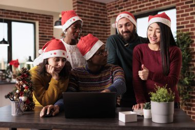 Festival ofisinde dizüstü bilgisayar kullanan çok ırklı bir grup Noel tatilinde yeni bir iş kuruyor. Xmas süslemeleri ile dekore edilmiş işyerinde takım çalışması yapmak.