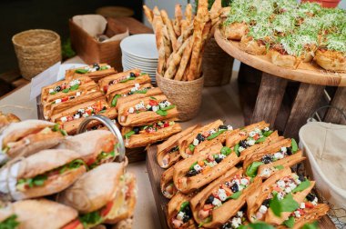 Etkinlikte puf böreği sosisli sandviç, fesleğen yapraklı sosisli sandviç ve peynir.