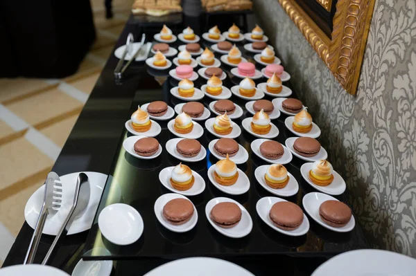 sweets on the catering table , biscuit cakes with chocolate macaroons