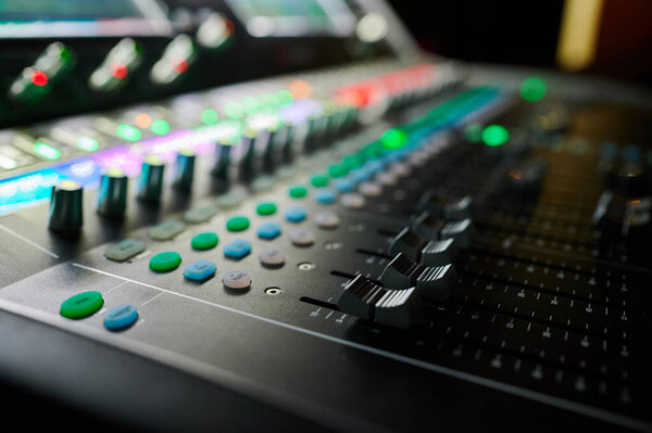 Close-up of a working sound mixer at an event in a concert under the control of a sound engineer