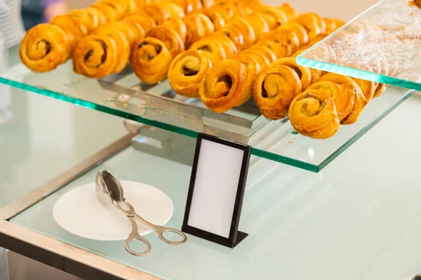 Cinnabon on a tray, pastries on a catering table, close-up shot