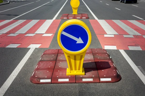 safety island with car traffic direction sign for auto, pedestrian crossing in the city