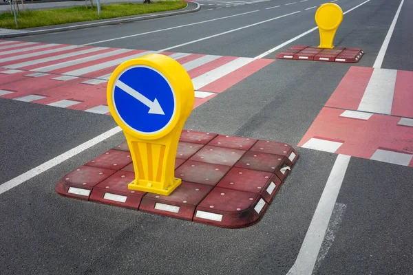 safety island with car traffic direction sign for auto, pedestrian crossing in the city