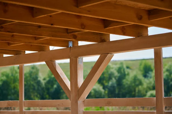 Roof of beams in a wooden gazebo under a canopy