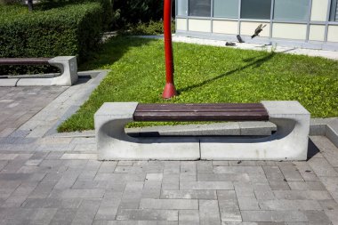 stone seating for relaxing in a landscaped park, concrete forms of slabs for decorating in a park