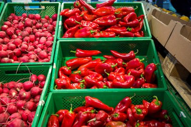 bell peppers on the counter, fresh vegetables in boxes in the supermarket for customers