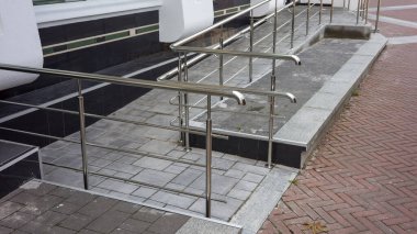 metal steel railings facade path near the building, path for the arrival of visitors with strollers and wheelchairs, for lifting disabled people