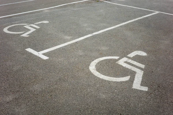 parking for the disabled, road markings for cars on the asphalt of the supermarket, shot close-up