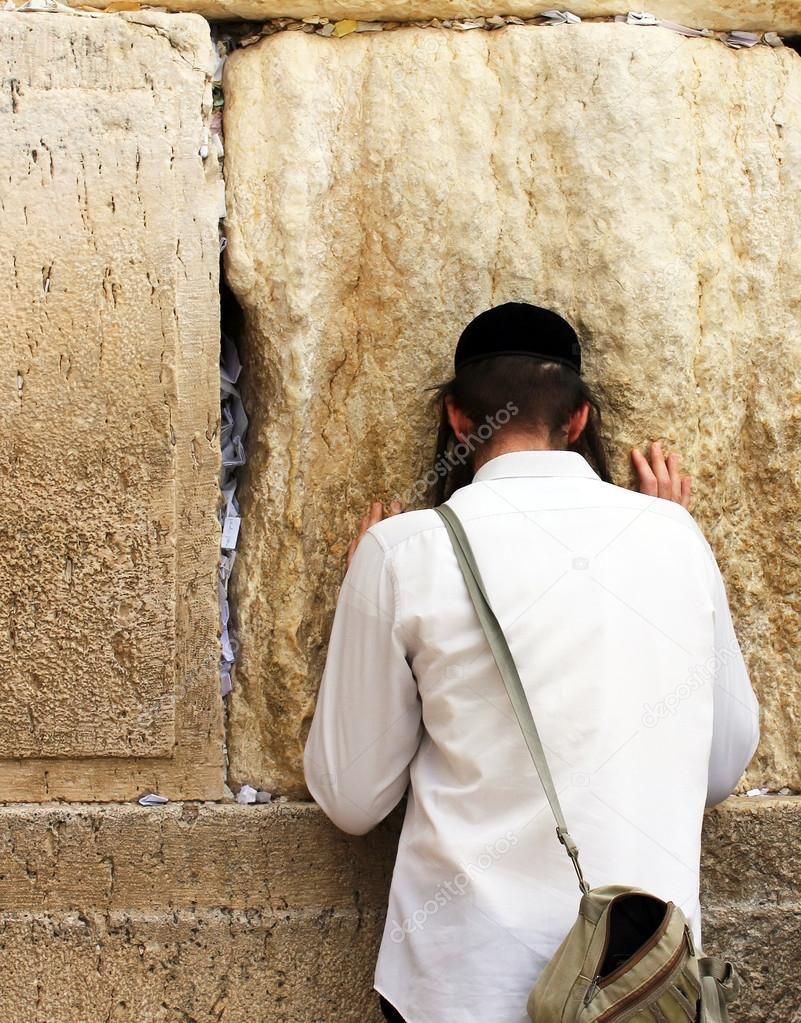 Unidentified young man praying at the Wailing wall (Western wall)