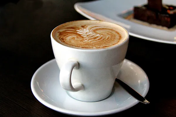 Cappuccino cup with drawing on scum — Stock Photo, Image