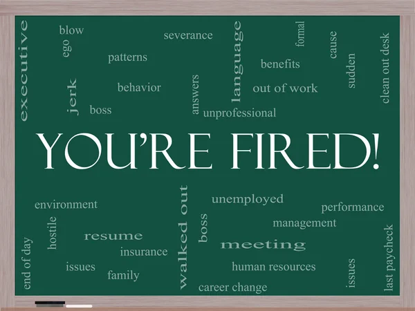 You 're Fired Word Cloud Concept on a Blackboard — стоковое фото