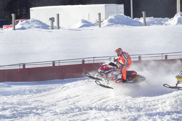 Red and Black Polaris Snowmobile Racing over jump — Stock Photo, Image