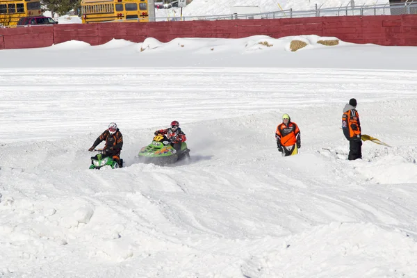 Two snowmobiles making a turn — Stock Photo, Image