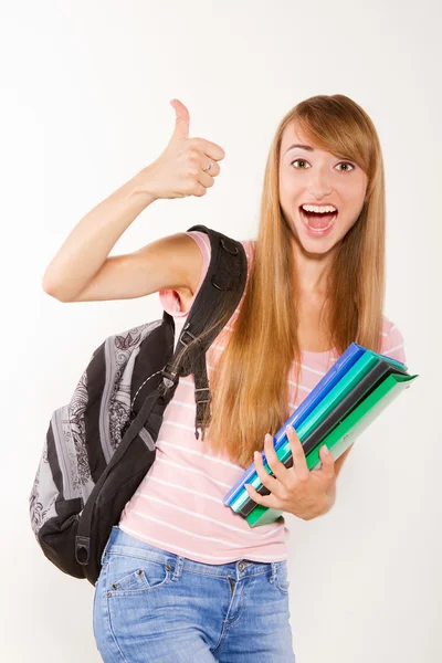 Smiling female student with books in hands Stock Photo