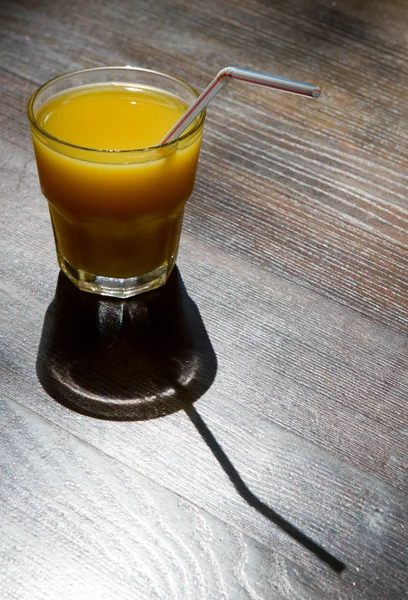 Glass of juice on wooden table — Stock Photo, Image