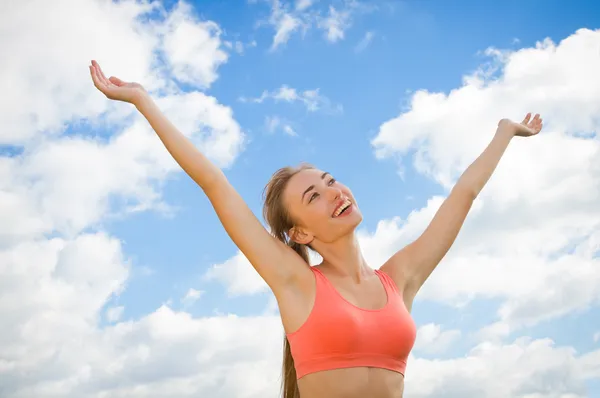 Smiling woman on the sky background — Stock Photo, Image