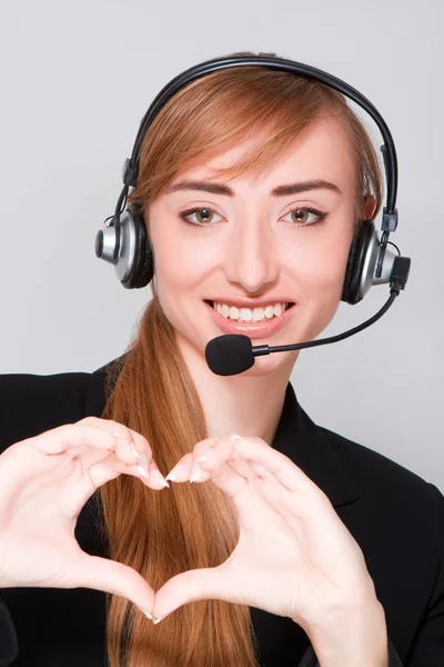Girl with headphones shows heart. — Stock Photo, Image