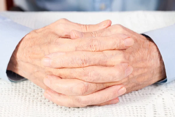 Crossed hands of elderly man — Stock Photo, Image