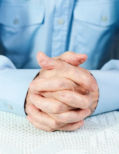 Crossed hands of elderly man — Stock Photo, Image