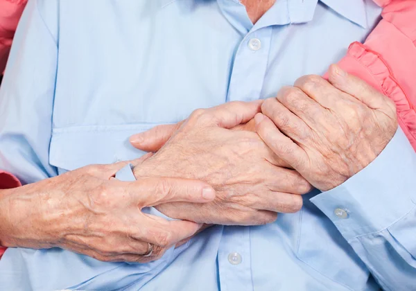 Hands of elderly pair by CU, hugs