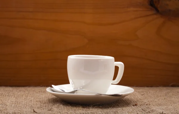 Cup of coffee on burlap background — Stock Photo, Image