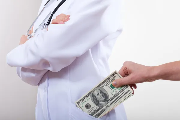 El paciente pone dinero en su bolsillo médico . — Foto de Stock