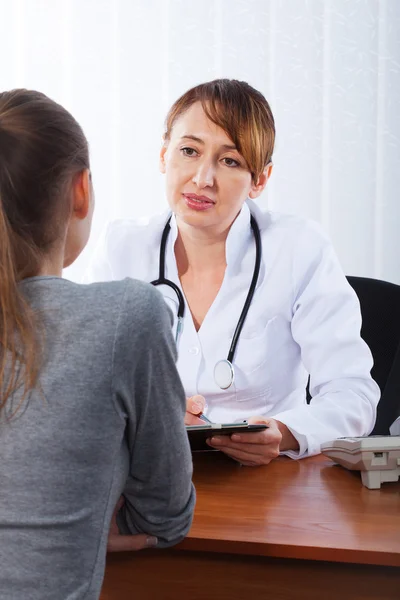 Doctor with female patient Royalty Free Stock Images