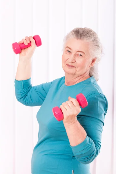 Happy senior woman with dumbbells — Stock Photo, Image