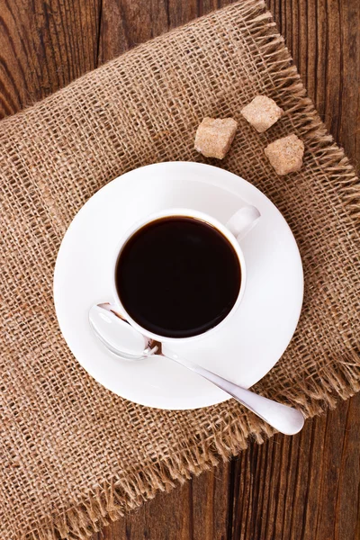 Kaffeetasse und Untertasse auf Holztisch. — Stockfoto