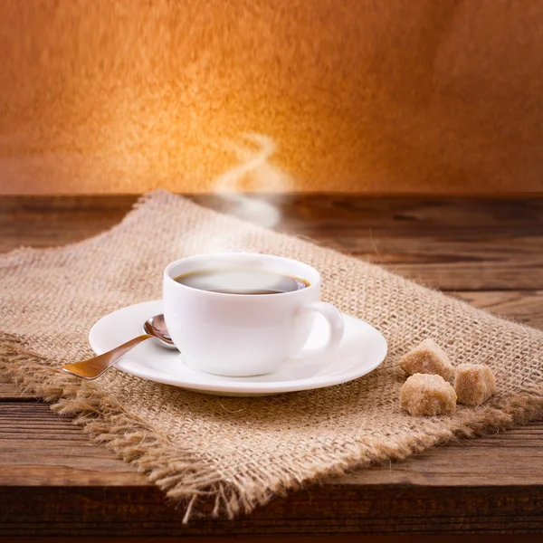 Coffee cup and saucer on wooden table. — Stock Photo, Image