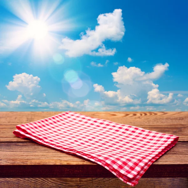 Empty wooden deck table with tablecloth — Stock Photo, Image