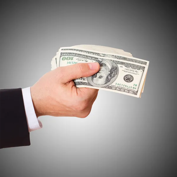 Businessman giving cash dollars in the hands — Stock Photo, Image