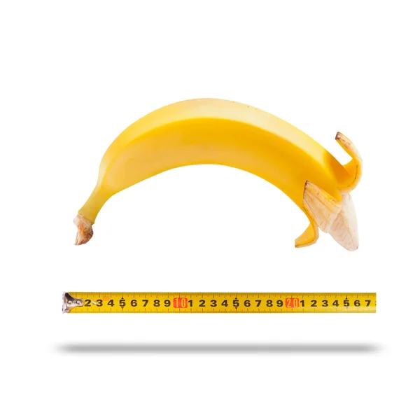 Duży banan i taśma pomiarowa jako obraz penisa — Zdjęcie stockowe