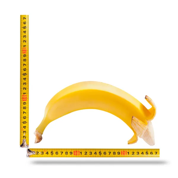 Великий банан і вимірювальна стрічка як зображення статевого члена людини — стокове фото