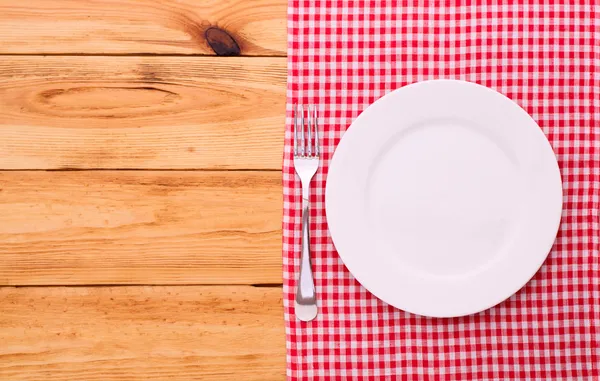 Cutlery red checkered tablecloth tartan on  wooden table top view. — Stock Photo, Image