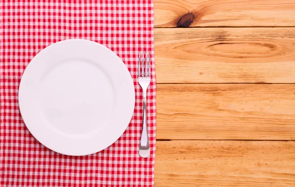 Cutlery red checkered tablecloth tartan on  wooden table top view. — Stock Photo, Image
