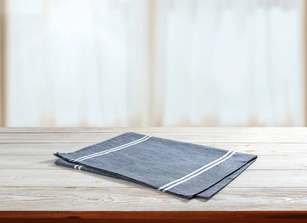 Napkin on wooden desk perspective. Kitchen background selective focus.