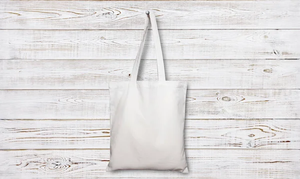 Fabric bag isolated on wooden background