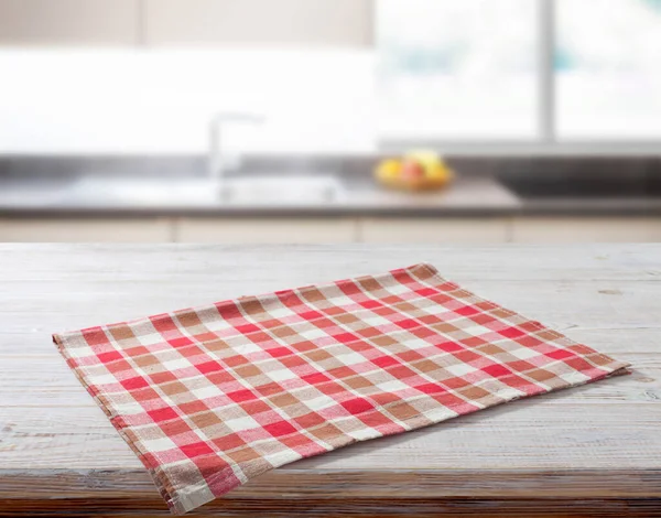 Folded towel, napkin linen tablecloth on wooden desk perspective. Mock up. Selective focus.