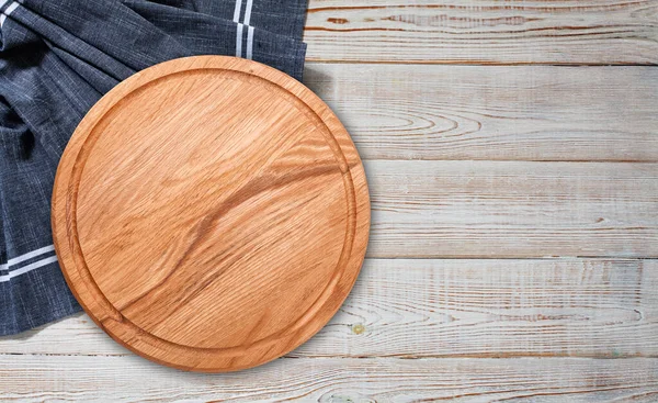 Pizza board with a napkin on white wooden table. Top view mock up