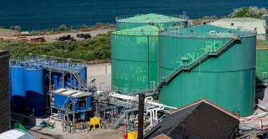 big green fuel tanks at a harbor in the UK